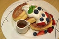 Delicious Souffle Pancake with Maple Syrup, Fresh Whipped Cream and Mix Berries Served on white Plate Royalty Free Stock Photo