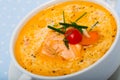 Delicious soup with salmon, served in white bowl at table Royalty Free Stock Photo
