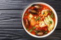 Delicious soup with seafood, corn, celery, tomatoes, carrots and avocado close-up in a bowl. Horizontal top view Royalty Free Stock Photo