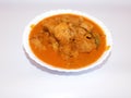 Delicious south Indian chicken curry with bowl isolated on white background Royalty Free Stock Photo
