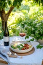 Delicious spaghetti dish with basil and wine outdoors Royalty Free Stock Photo
