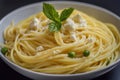 Delicious spaghetti dish with cheese, peas, and mint garnish in white bowl Royalty Free Stock Photo