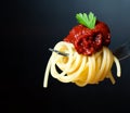 Delicious spaghetti on fork close-up. black Royalty Free Stock Photo
