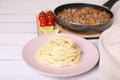 Delicious spaghetti, minced meat and tomatoes on white wooden table Royalty Free Stock Photo