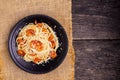 Delicious spaghetti pasta with prawns and cheese served in a black bowl on a black background table Italian recipe, tomato sauce, Royalty Free Stock Photo