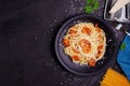 Delicious spaghetti pasta with prawns and cheese served in a black bowl on a black background table Italian recipe, tomato sauce, Royalty Free Stock Photo