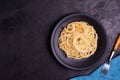 Delicious spaghetti pasta with prawns and cheese served in a black bowl on a black background table Italian recipe, tomato sauce, Royalty Free Stock Photo