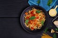 Delicious spaghetti pasta with prawns and cheese served on a black plate on a black background table Italian recipe, tomato sauce Royalty Free Stock Photo