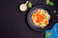 Delicious spaghetti pasta with prawns and cheese served on a black plate on a black background table Italian recipe, tomato sauce Royalty Free Stock Photo