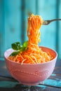 Delicious spaghetti pasta twirled on fork above bowl with basil garnish on rustic blue background