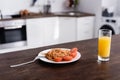 Spaghetti and tomato on plate near