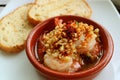 Delicious Spanish Style Garlic Shrimp or Gambas al Ajillo with Blurry Sliced Breads in Background
