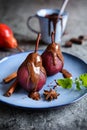 Poached pears in red wine and topped with chocolate sauce Royalty Free Stock Photo