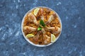 Delicious spicy chicken Biryani in white bowl on black background, Indian or Pakistani food.