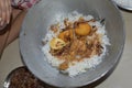 Delicious spicy homemade chicken biryani making in bowl by an indian woman