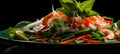 Delicious spicy thai seafood salad on black plate with vibrant background copy space available