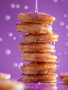 Delicious Stack of Golden Pancakes Drenched in Sweet Maple Syrup with Droplets Captured Mid Air Against a Purple Background