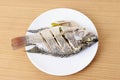 Delicious steamed fish on wooden table