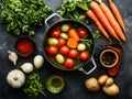 Delicious stew with vegetables in pot and ingredients on gray textured table, flat lay. Space for text Royalty Free Stock Photo