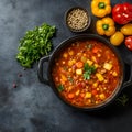 Delicious stew with vegetables in pot and ingredients on gray textured table, flat lay. Space for text Royalty Free Stock Photo