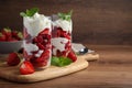 Delicious strawberries with whipped cream served on wooden table. Space for text Royalty Free Stock Photo