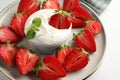 Delicious strawberries with whipped cream on white table, closeup Royalty Free Stock Photo