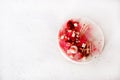 Delicious strawberry cheesecake, fresh berries, coconut, and sweet decor element on top, white concrete background