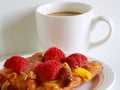 A delicious Strawberry Danish pastry and a white cup of coffee on white background Royalty Free Stock Photo