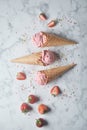 Delicious strawberry ice cream cone with fresh strawberry on marble background. top view Royalty Free Stock Photo