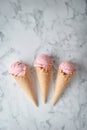 Delicious strawberry ice cream and waffle cone on marble background, top view Royalty Free Stock Photo