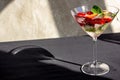 cooling strawberry cocktail with ice and mint on black and concrete background, stylish and tasty, unusual martini Royalty Free Stock Photo