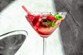 cooling strawberry cocktail with ice and mint on black and concrete background, stylish and tasty, unusual martini Royalty Free Stock Photo