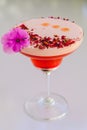 Strawberry rose cocktail with purple flower