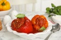 Delicious stuffed peppers with basil in bowl on white marble table Royalty Free Stock Photo