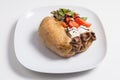 Delicious stuffed sweet potato with cheese, anchoa, tomato and salad