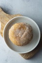 Delicious sugar donuts on a white plate, rustic style