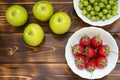 Delicious summer harvest fruits and berries in wooden table with copy space.