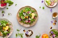Delicious summer salad with edible flowers, vegetables, fruit, microgreens and cheese. Clean and healthy eating concept. Top view