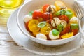 Delicious summer salad of yellow and red cherry tomatoes, mozzarella with Basil Royalty Free Stock Photo