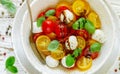 Delicious summer salad of yellow and red cherry tomatoes, mozzarella with Basil Royalty Free Stock Photo