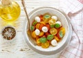 Delicious summer salad of yellow and red cherry tomatoes, mozzarella with Basil Royalty Free Stock Photo