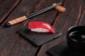 Delicious sushi maguro tuna. Nigiri with tuna on black and wooden background . Traditional Japanese cuisine