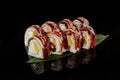 Sushi rolls with eel, cream cheese and orange on bamboo leaf Royalty Free Stock Photo