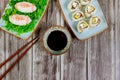 Delicious sushi and rolls with soy sauce and chopstick for american football game party
