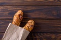 Delicious sweet bun with cinnamon in kraft package Royalty Free Stock Photo