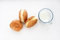 Delicious sweet buns with jam and a glass of milk on a white background. A delicious breakfast of beautifully fried buns and milk Royalty Free Stock Photo