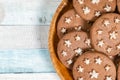 Delicious sweet cocoa cookies biscuits on a wooden plate .