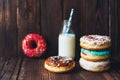 Delicious sweet covered colored donut glaze and a bottle of milk Royalty Free Stock Photo