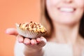 Delicious sweet cupcake in human hand. Gluttony Royalty Free Stock Photo