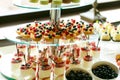 Delicious sweet cupcakes and pastry at wedding dessert table re Royalty Free Stock Photo